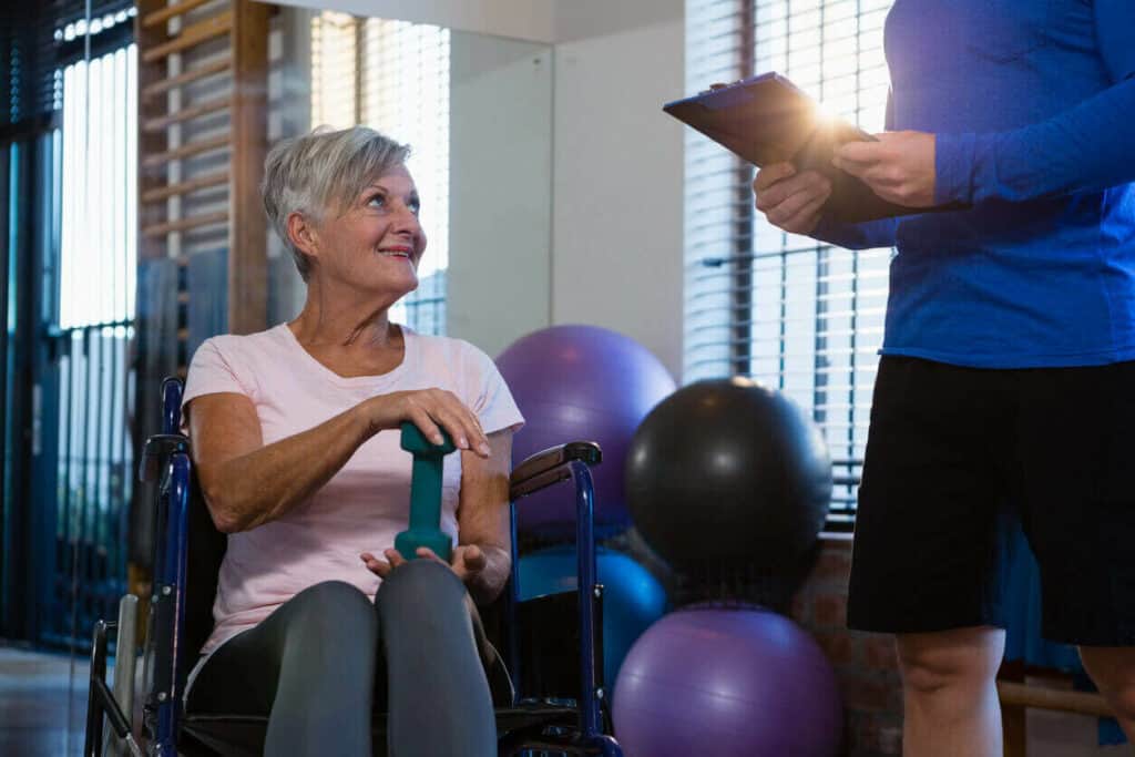 Eldelry woman interacting with a physical therapist about her fitness goal - exercises for senior citizens