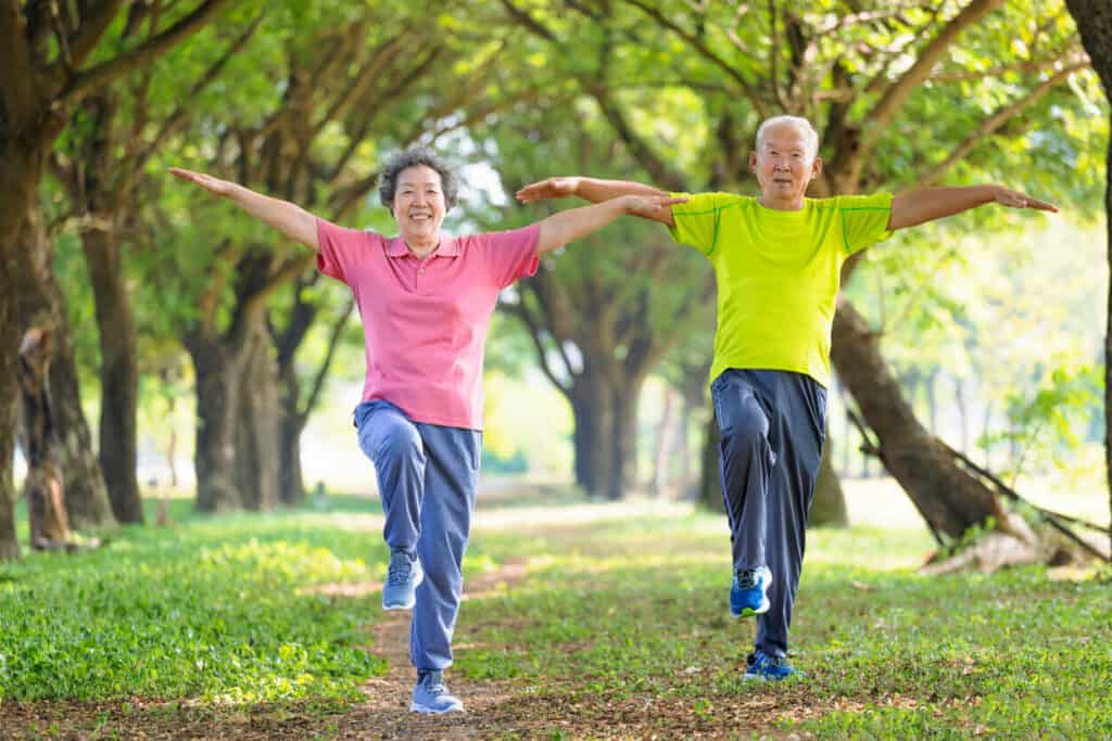 a senior couple enjoying balance activities for older adults in the park