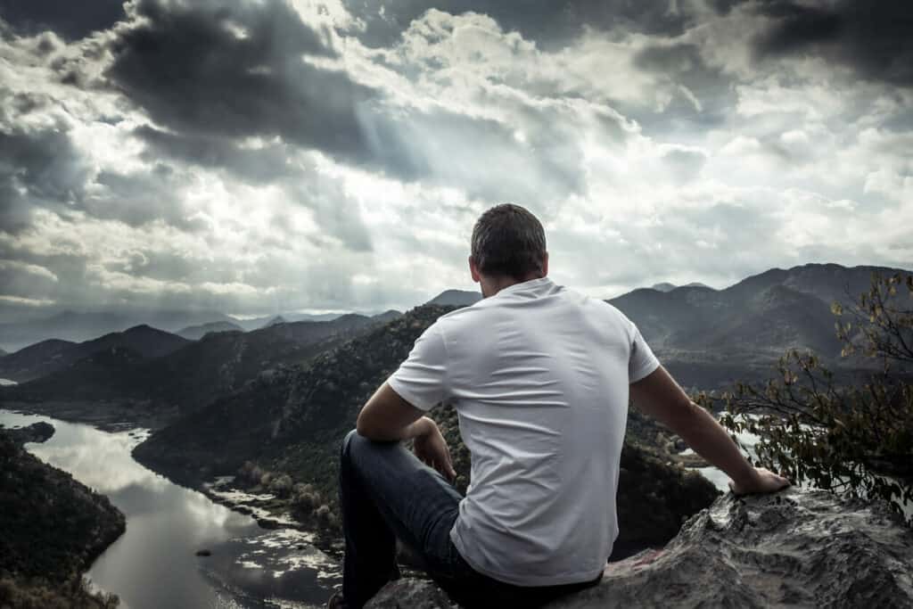 an older son looking at the horizon hoping to find elder care support for his parents' caregiver