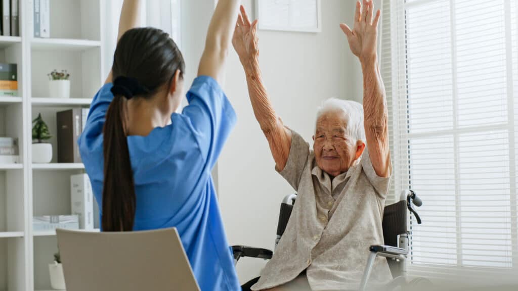 Mental health caregiver support - a nurse caregiver helping a senior woman with therapy.