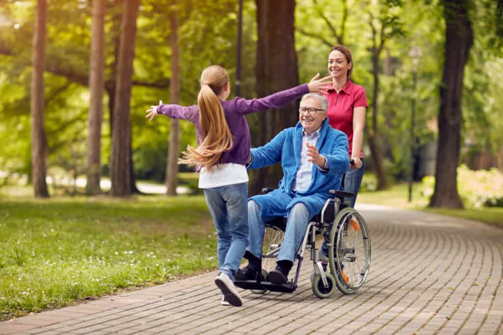 Mental health caregiver - a cheerful senior man being assisted by a caregiver.