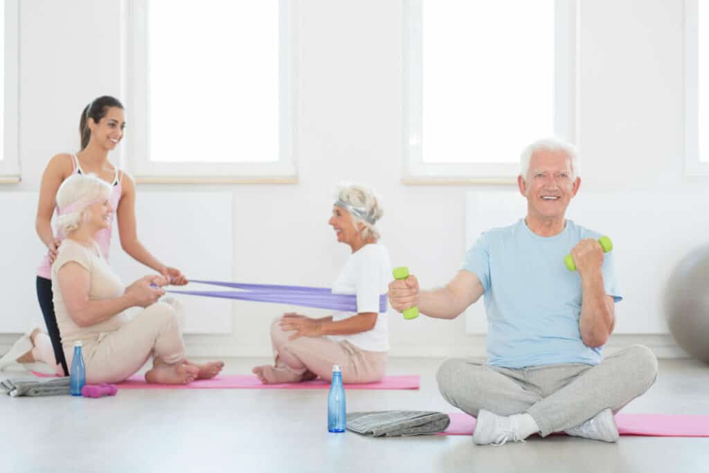 Older adults are exercising together with resistance bands - list of balance exercises for seniors