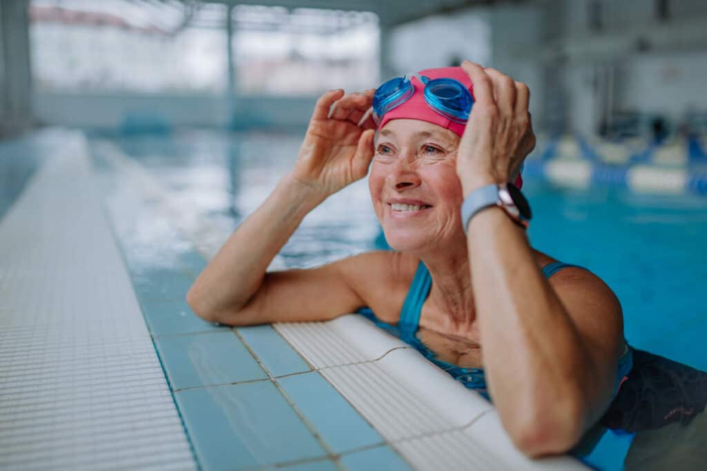Happy senior woman in a swimming pool | Senior exercise classes in my area