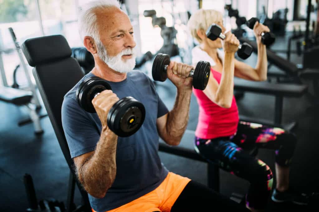 Senior woman and man exercising with dumbbells | Free senior exercise classes