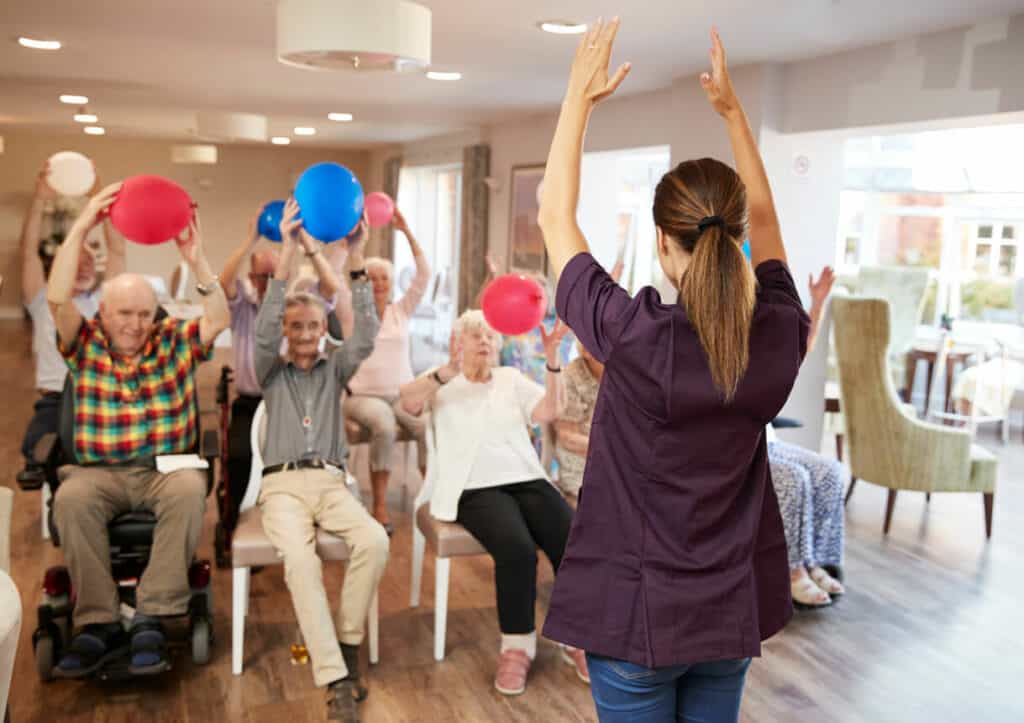 Carer leading a group of seniors in a fitness class | Senior exercise programs in the US