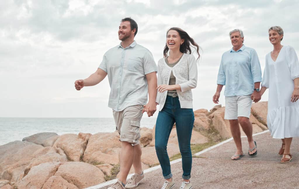 a happy family enjoying spending quality together at the beach to avoid caregiver strain in 2023