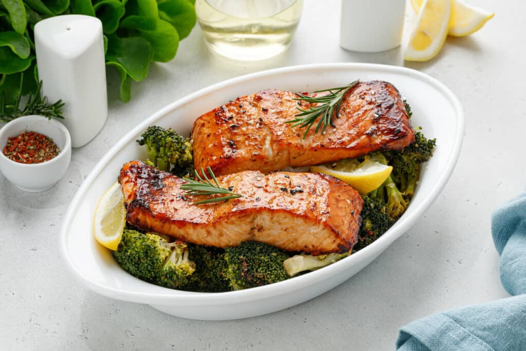 Platter of baked salmon with vegetables, a brain-healthy recipe for your elderly loved one