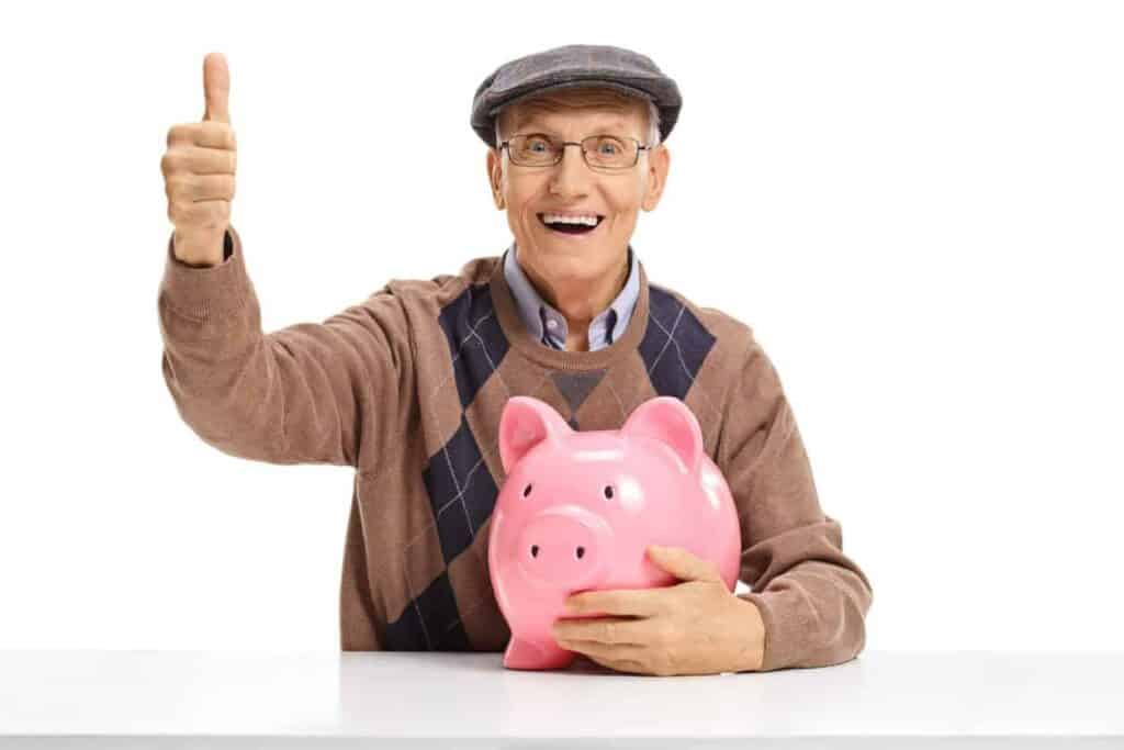 scam victim - a senior holding a piggy bank.