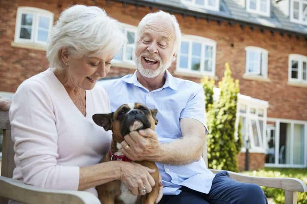A happy senior couple with their dog in one of the care homes.