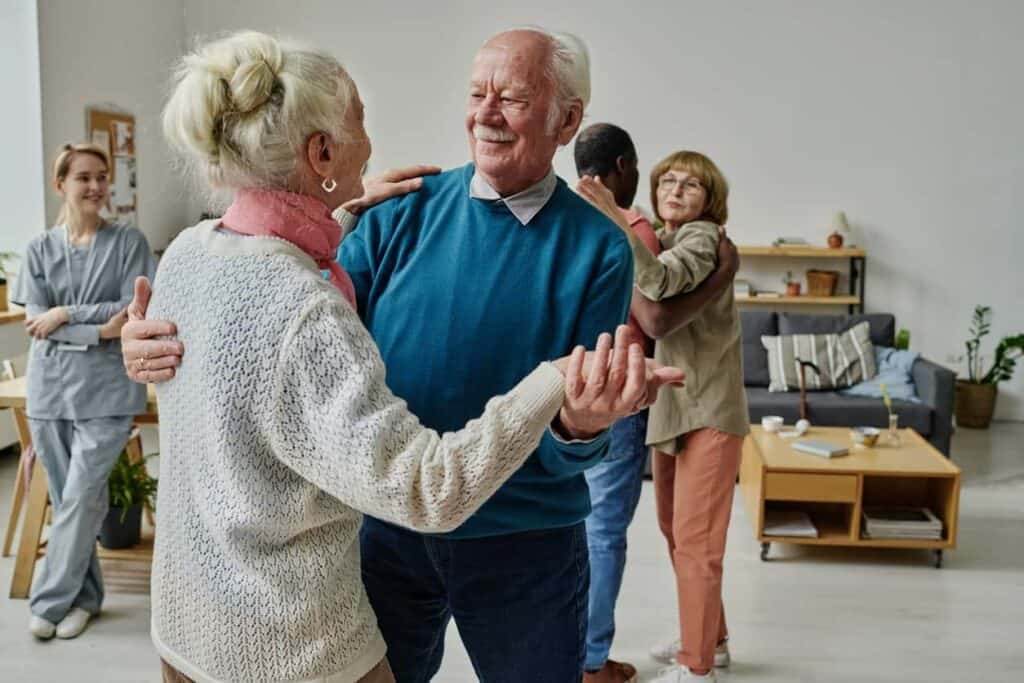 Senior couples cheerfully dancing in an assisted living facility in Carson City, NV.