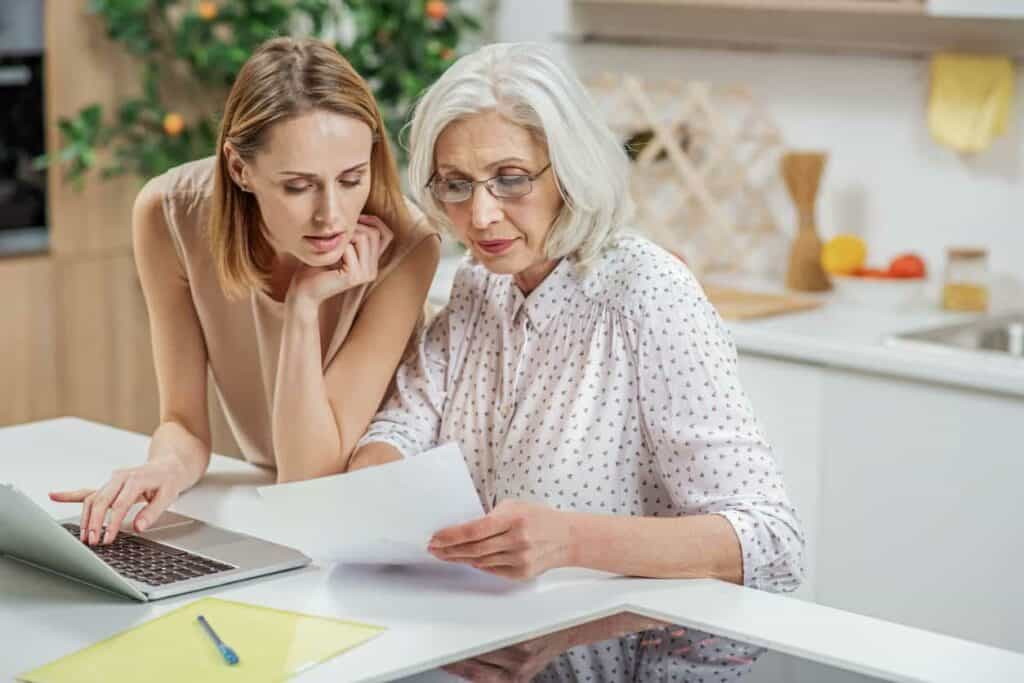 Elderly woman and her daughter filing a report after becoming victims of online fraud and looking for a reimbursement