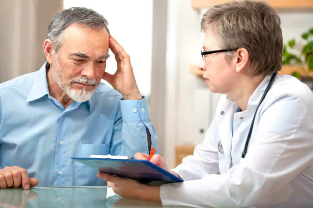 Doctor telling an older man about his dementia - patient teaching for dementia