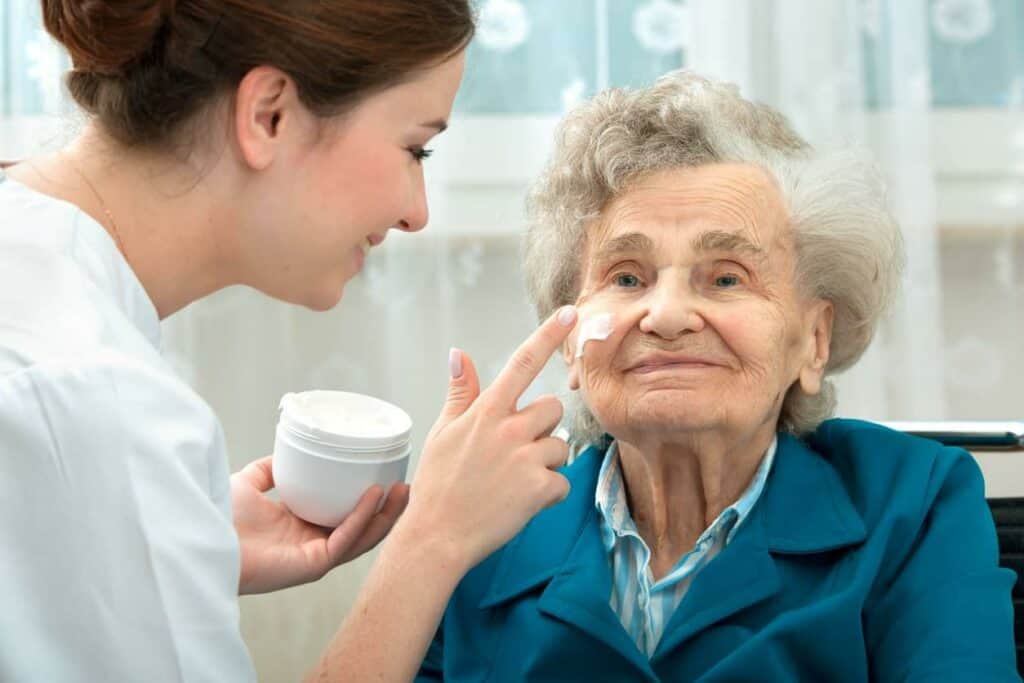 a nurse helping an older woman take care of her skin/ in-home health care in Carson City