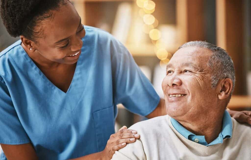 a caregiver assisting an older man at a memory care facilities