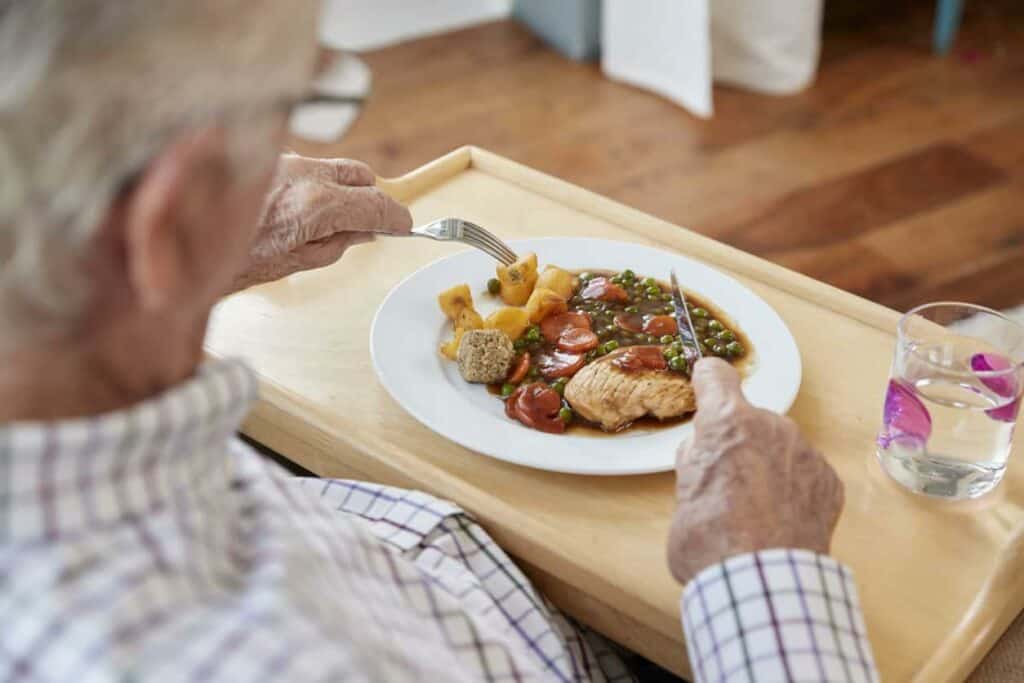 a senior enjoying a home-cooked meal at Carson City memory care