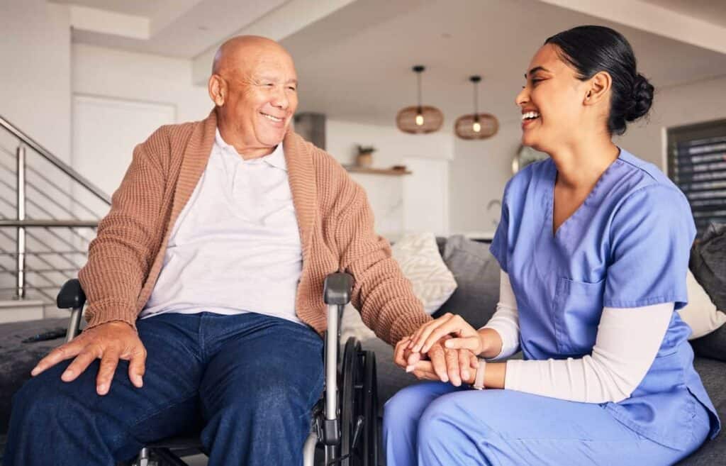 Senior Asian man with Sundowners Syndrome sharing a joke with his caregiver | What are the early signs of sundowners