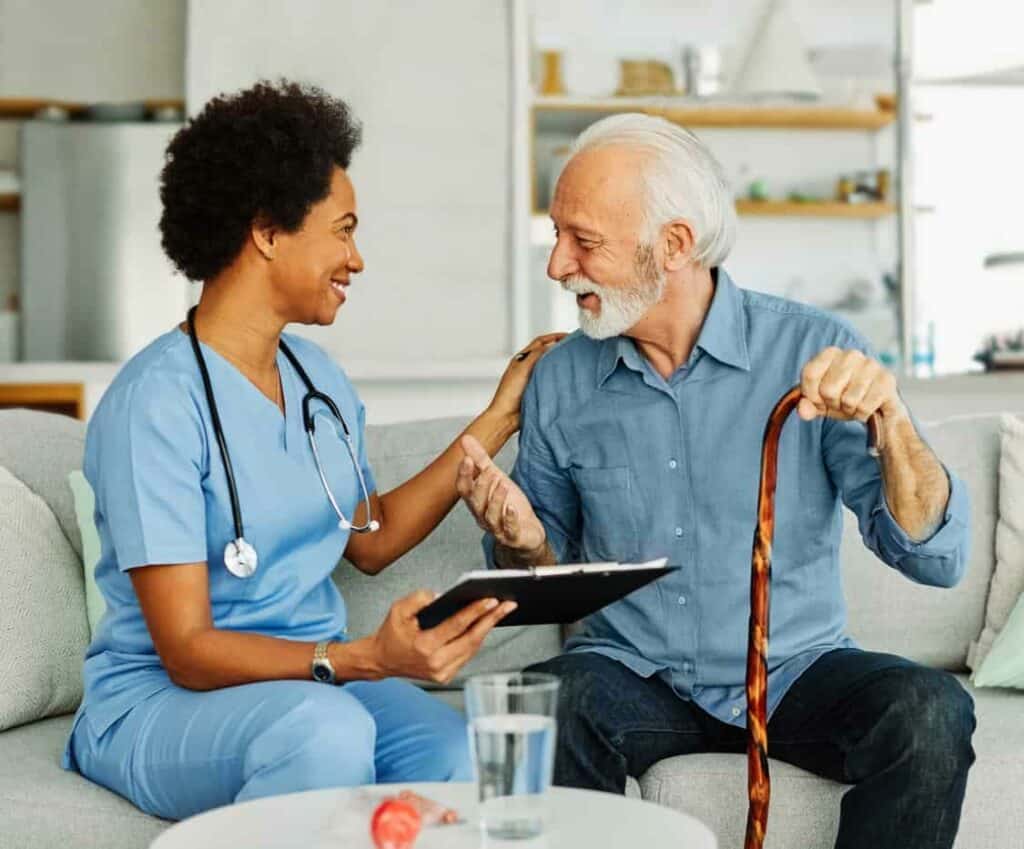 A nurse visiting a senior patient to provide in home health care.