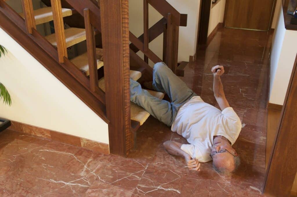 an older man who has fallen down the stairs, injuring his back