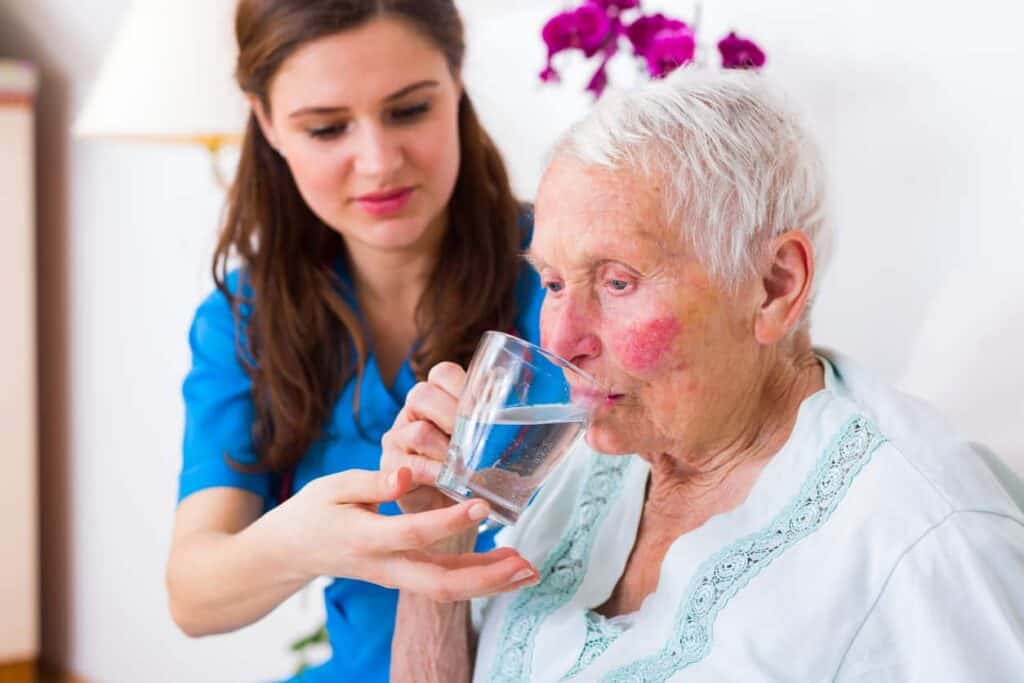 elderly woman taking a pill - sundowning treatment