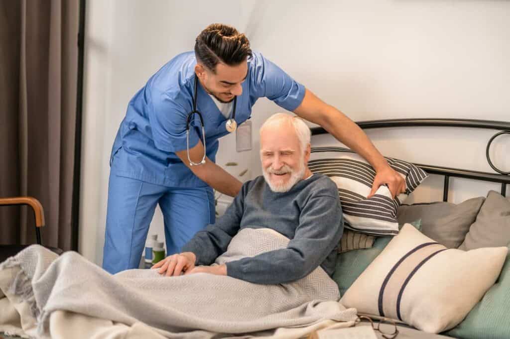 a caregiver assisting a bedridden senior experiencing memory loss