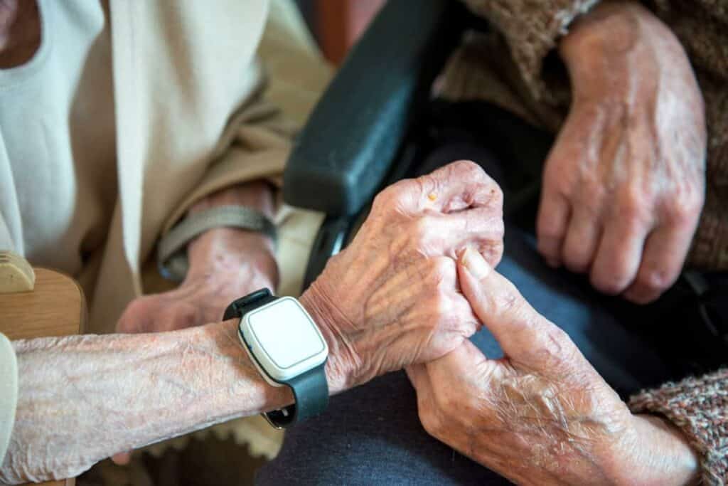 Caregiver holding hands of an elderly with vascular dementia - vascular dementia stages