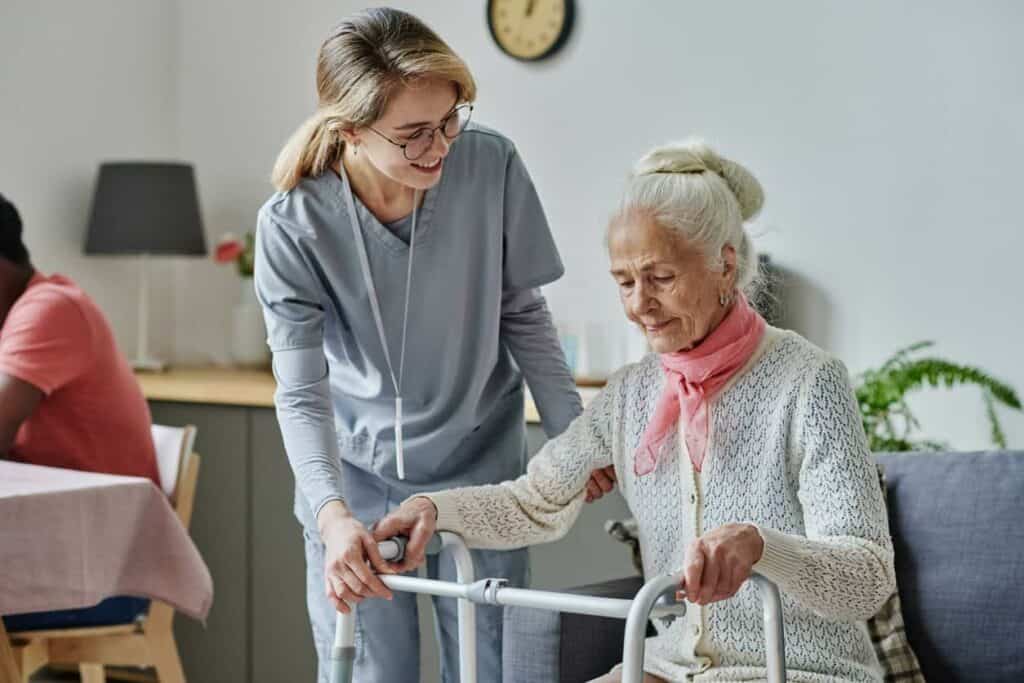 Young caregiver and older woman in a Medicaid assisted living facility