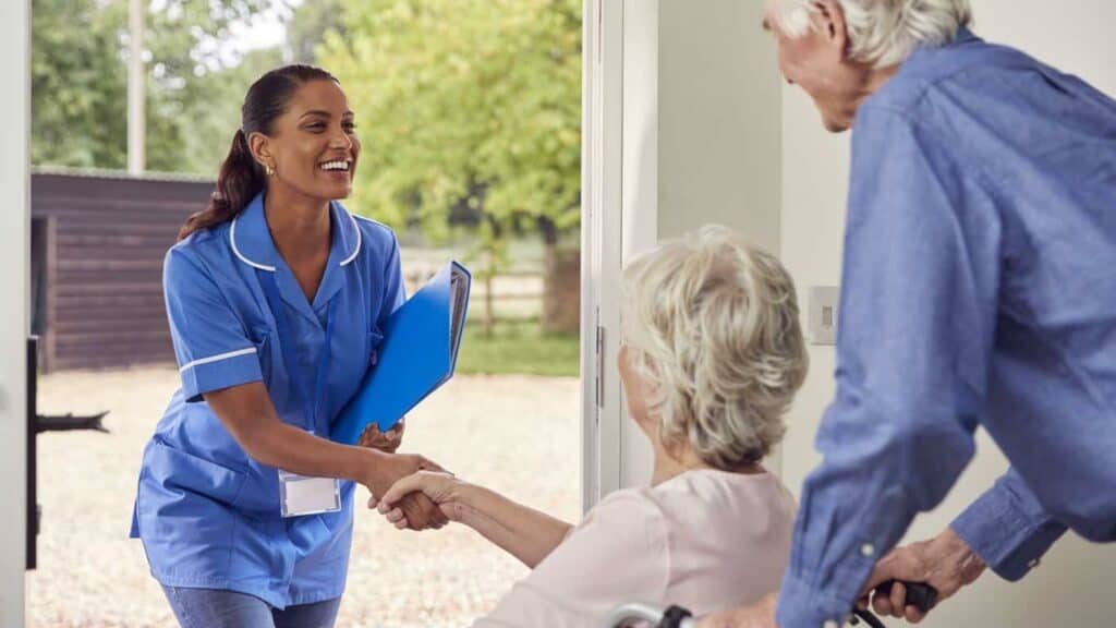 agency for home health care - senior man and woman talking to a home health aide