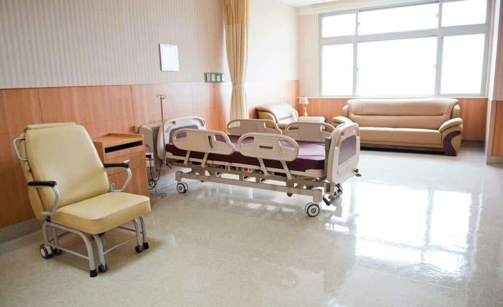 an empty nursing home room ready for a patient to move in