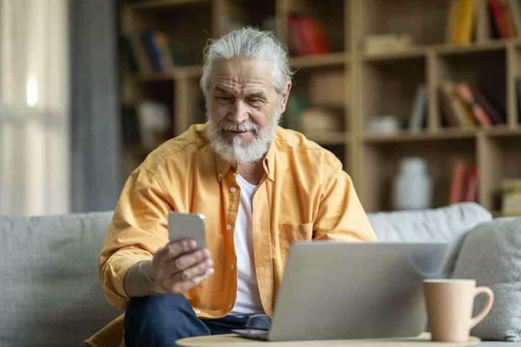 an older businessman working from the comfort of his apartment assisted living