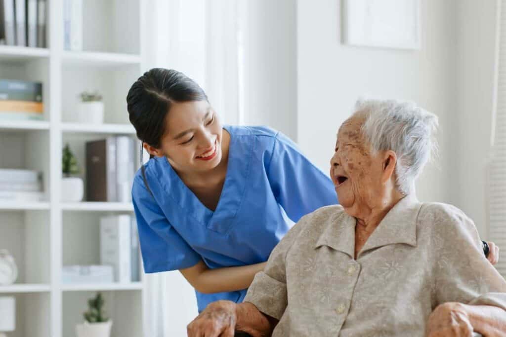 how to choose the right palliative care provider - older woman with caregiver laughing