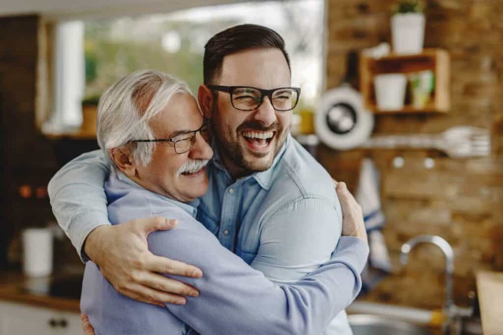 a happy father spending time with his son in the kitchen after confirming he is on a cancer trial program