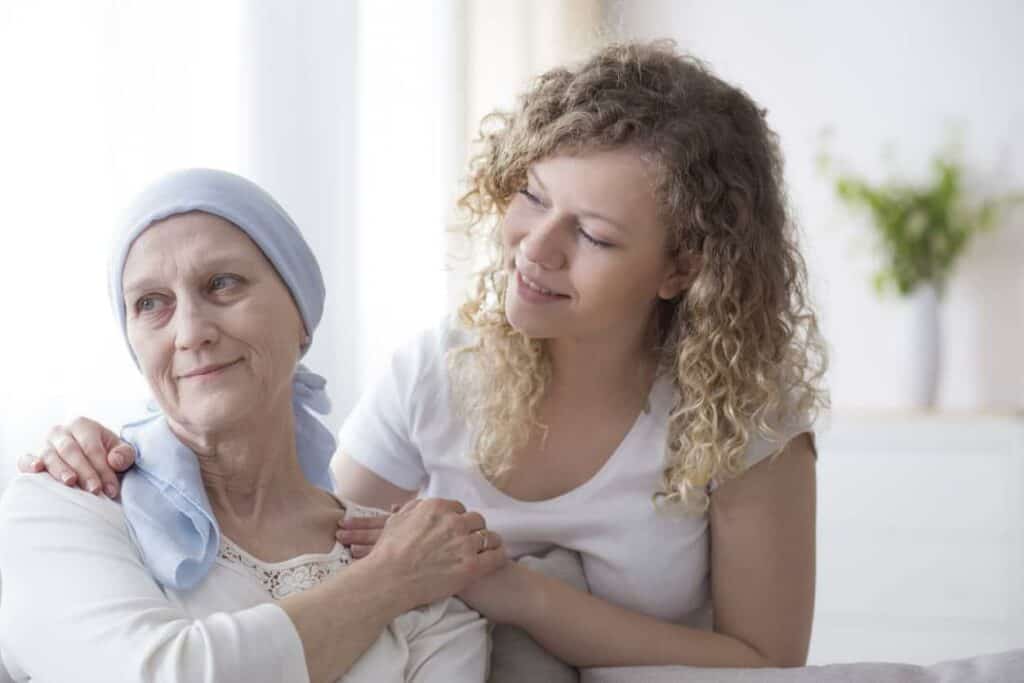 pain and palliative care - a daughter supporting her mom with cancer.