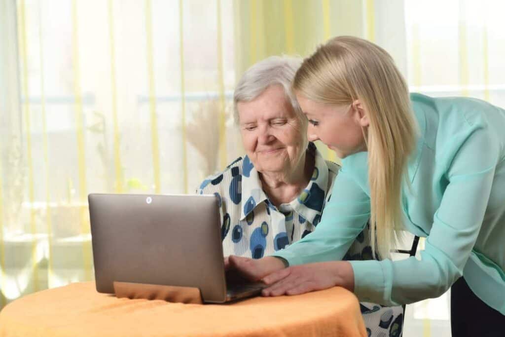 how to get palliative care - elder woman and her daughter browsing the web