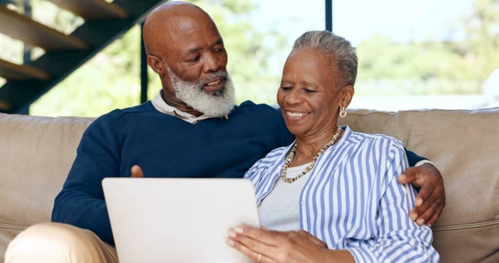 Black senior and wife researching what palliative treatment is better for her