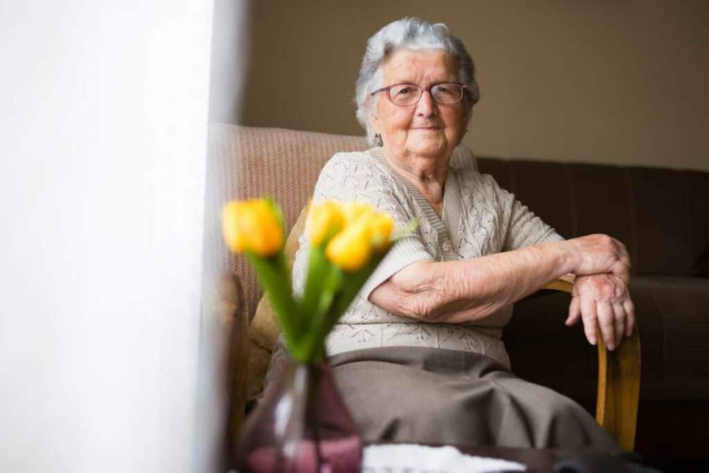 A beautiful, smiling senior in a retirement home - senior care home.