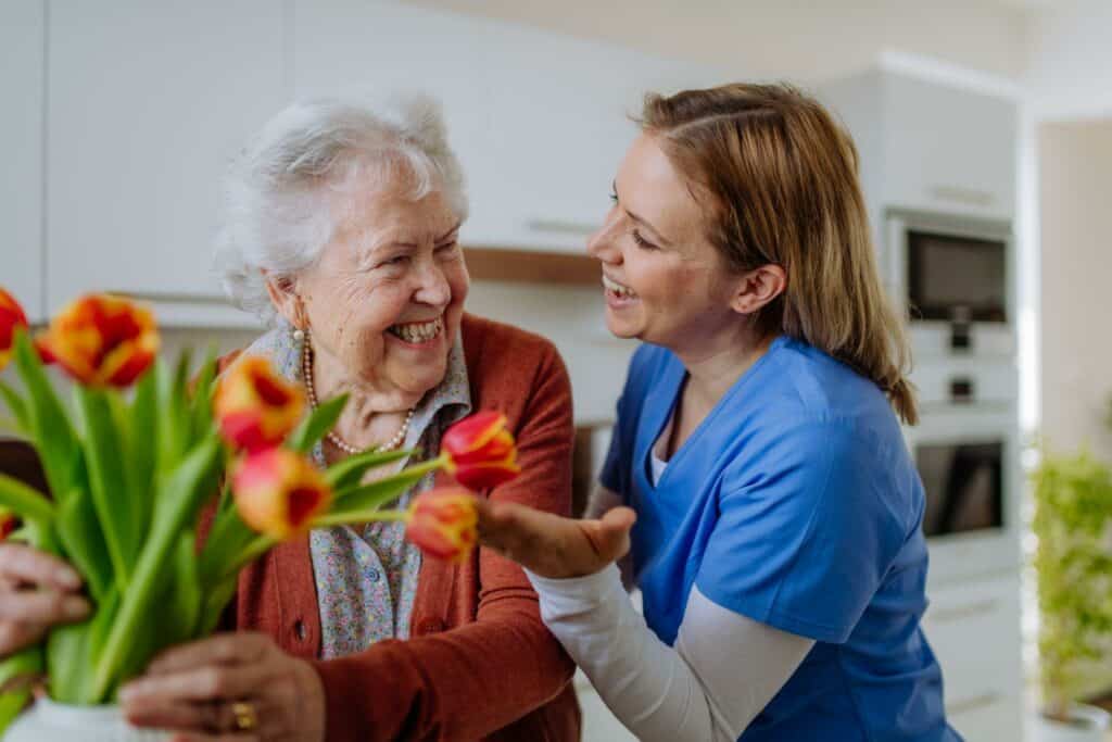 A happy senior woman with her caregiver - Nevada home care.