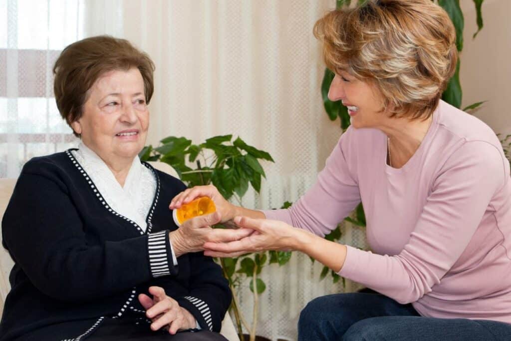 A caregiver helping a senior woman take her medication - Nevada home care
