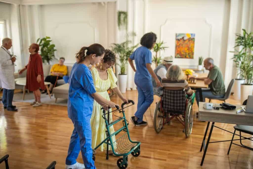 residents of a senior living facility with their caregivers