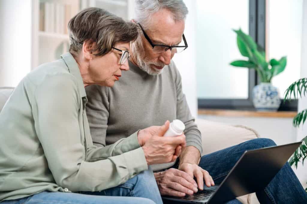 a senior couple checking if Medicare covers some of their prescriptions