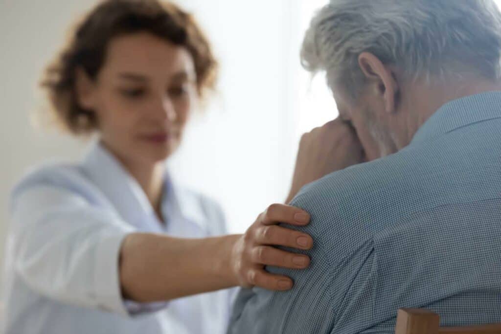 Man asking a doctor about hospice care in a hospice center