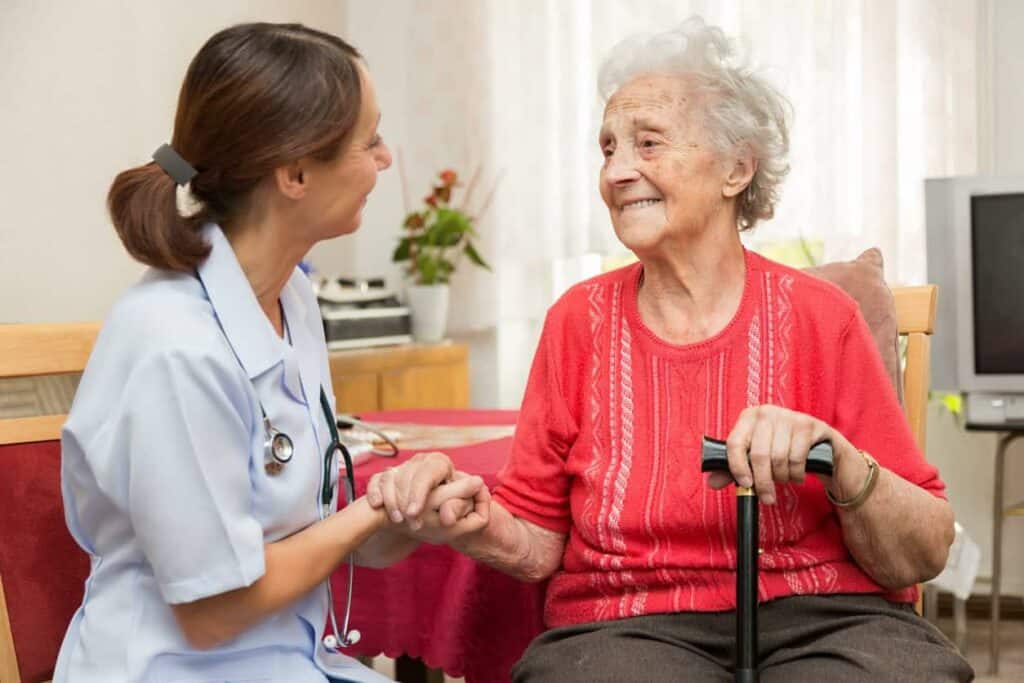 A nurse during a home visit with a senior woman