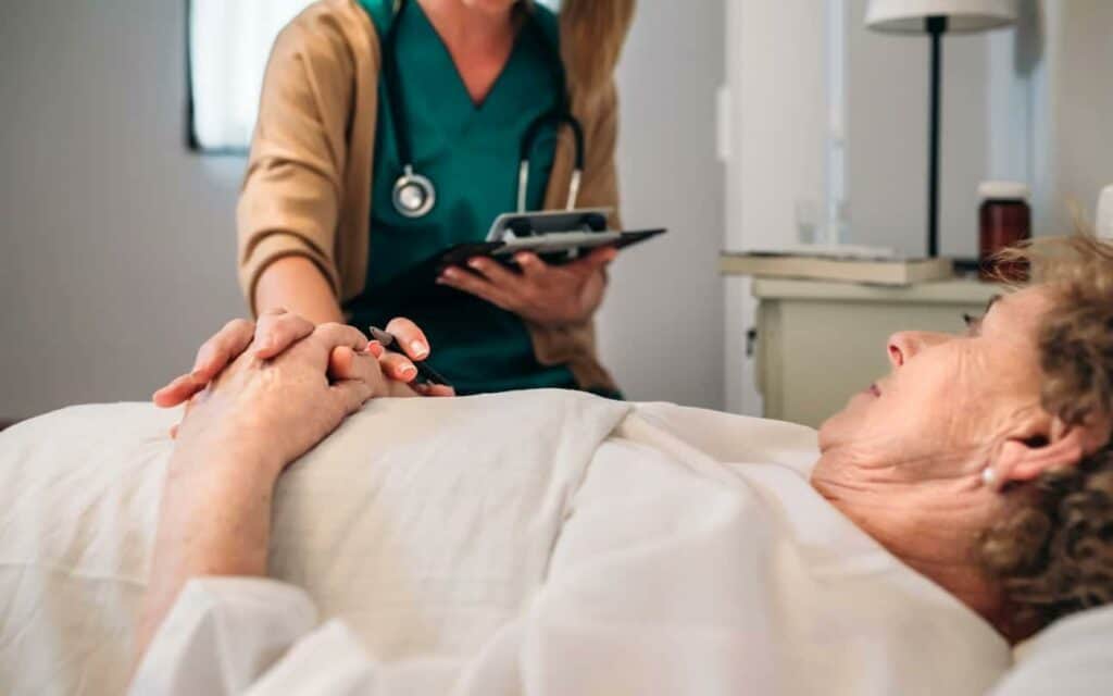 A female doctor getting the vitals of a hospice patient.