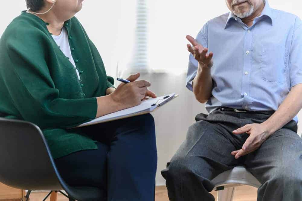 Senior explaining his emotional and spiritual concerns to a woman therapist | what is a major goal of hospice care