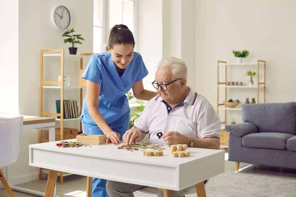 a skilled caregiver working on memory activities with senior residents