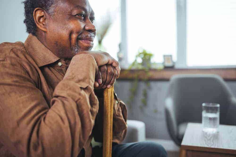 a senior man listening to an explanation on how he can cover the cost of memory care for his spouse