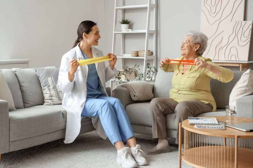 senior woman and therapist performing physical therapy exercises