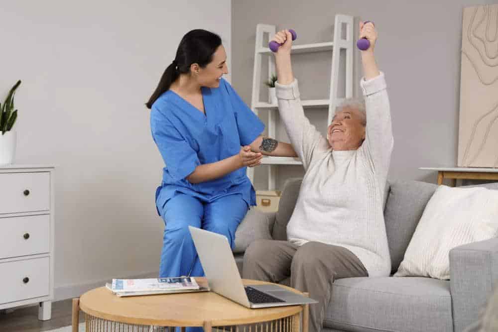 senior physical therapy improves mobility - senior woman with dumbbells