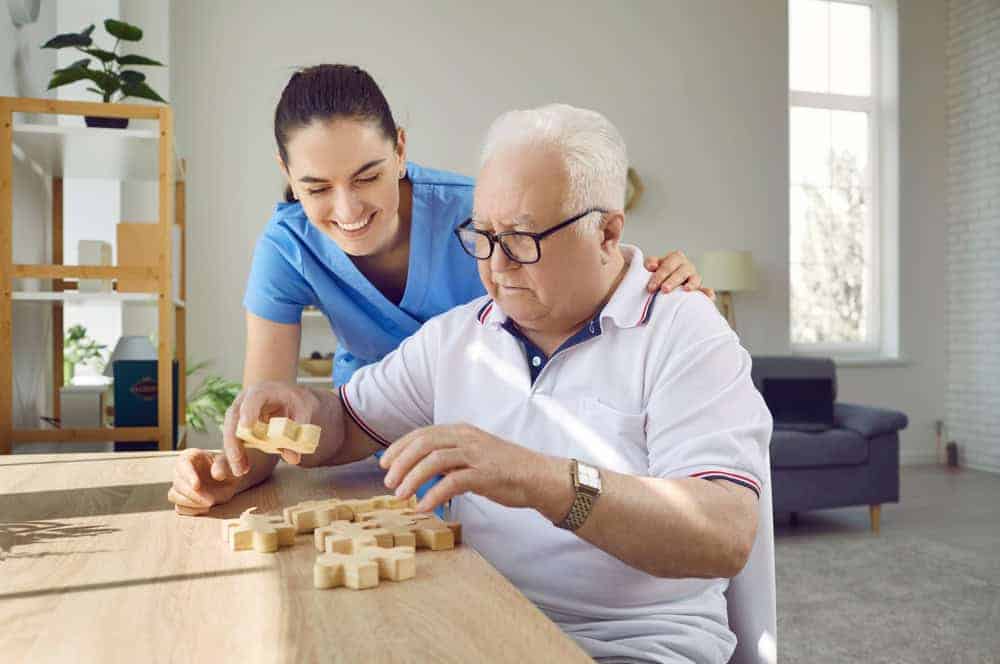 senior woman in a memory care facility playing a puzzle game