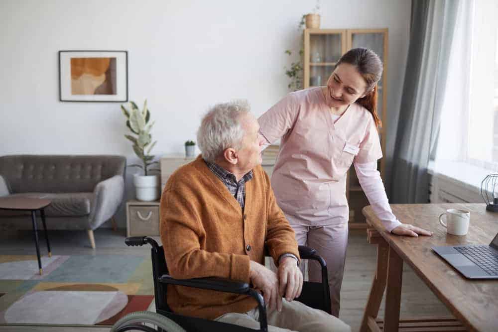 senior smile smiling with female caregiver in a nursing home | provided in nursing homes