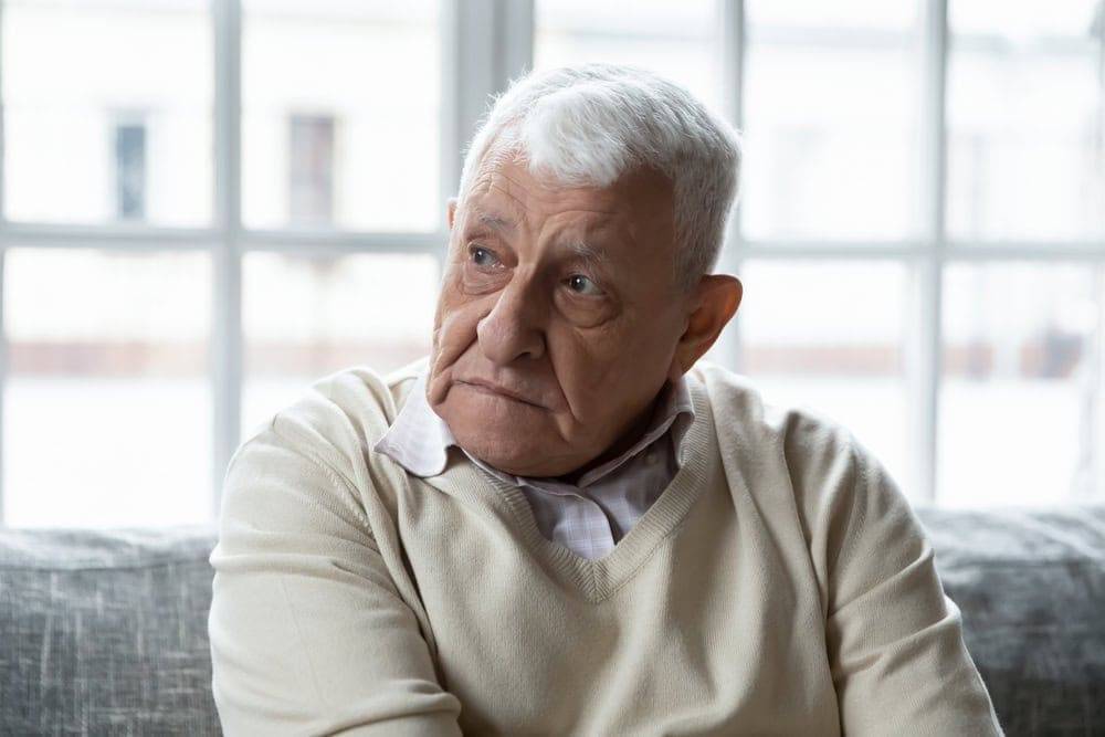 Senior man with Alzheimer’s disease looking sad